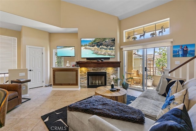 tiled living room with a fireplace and high vaulted ceiling