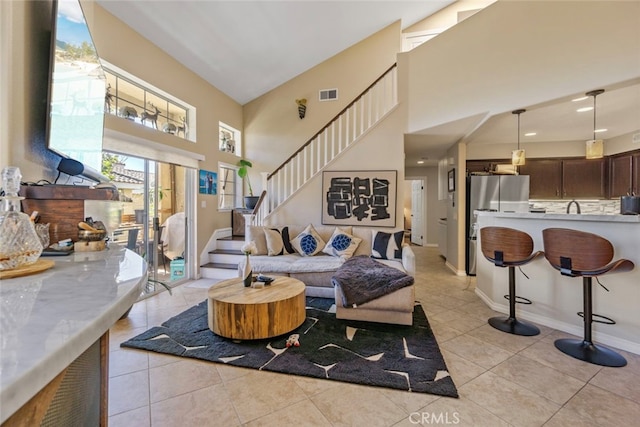 tiled living room with a high ceiling