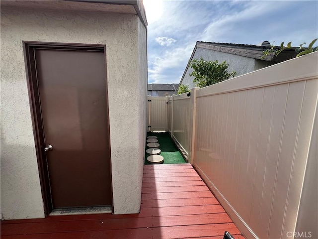 exterior space featuring fence and stucco siding