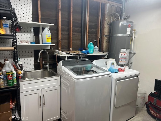 clothes washing area with a sink, laundry area, separate washer and dryer, and secured water heater