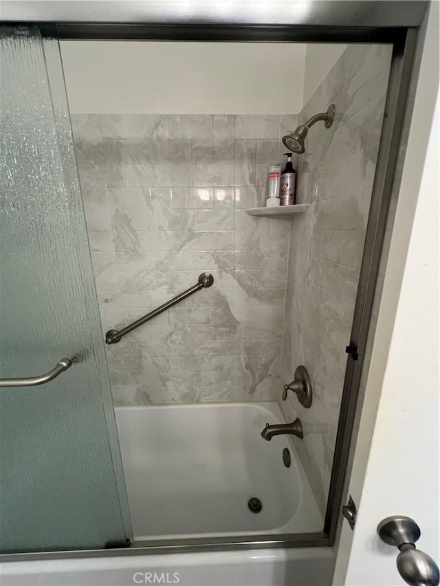 full bathroom with shower / bath combination with glass door