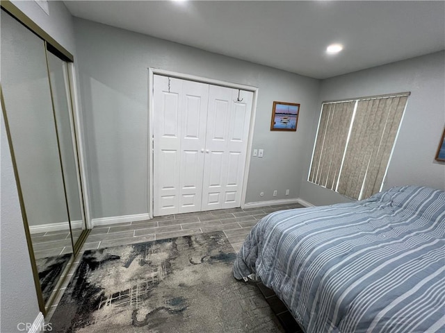 bedroom with wood tiled floor and baseboards