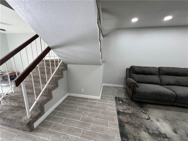 interior space with recessed lighting, stairs, baseboards, and wood finish floors