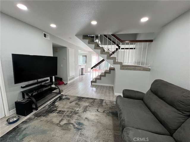 living area with visible vents, baseboards, wood tiled floor, stairs, and recessed lighting