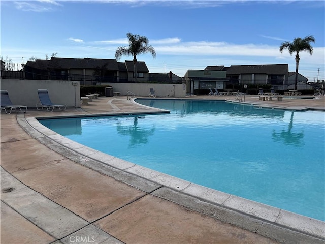 pool featuring a patio area and fence