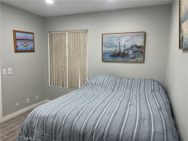 bedroom with wood tiled floor and baseboards