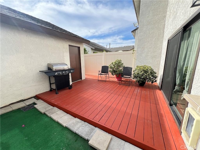 wooden deck with fence and grilling area