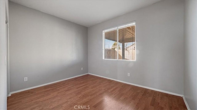 spare room with wood-type flooring