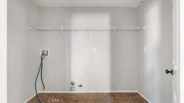 clothes washing area featuring hookup for a gas dryer and washer hookup