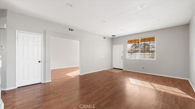 unfurnished room featuring dark hardwood / wood-style flooring