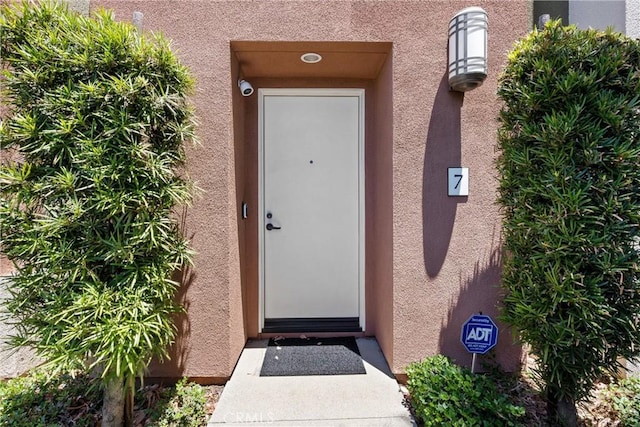 doorway to property with stucco siding