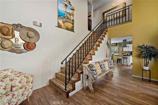 30451 San Pasqual Rd, Temecula, CA 92591 - stairway featuring baseboards, wood finished floors, and a high ceiling