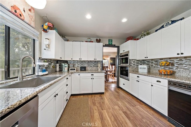 30451 San Pasqual Rd, Temecula, CA 92591 - kitchen with stainless steel appliances, a sink, backsplash, recessed lighting, and white cabinetry
