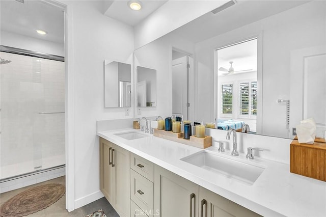 1632 Doheny Way, Dana Point, CA 92629 - ensuite bathroom with a stall shower, double vanity, tile patterned floors, ceiling fan, and baseboard heating