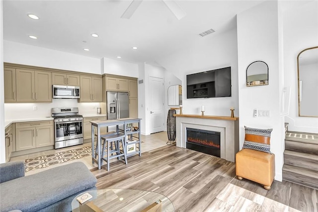 1632 Doheny Way, Dana Point, CA 92629 - living room featuring recessed lighting, light wood finished floors, ceiling fan, a glass covered fireplace, and baseboards