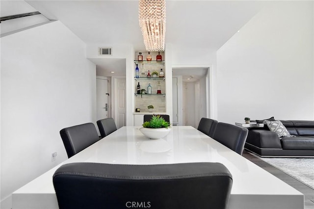 dining room featuring hardwood / wood-style floors and a notable chandelier