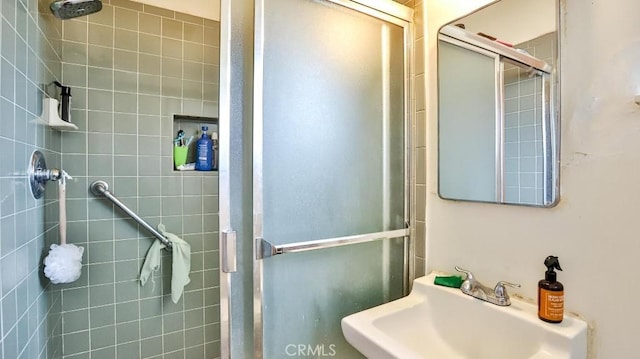 full bath featuring a sink and a shower stall