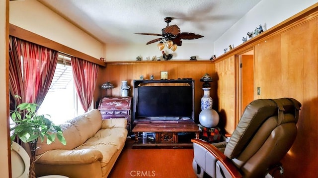 living room with a ceiling fan and wood finished floors