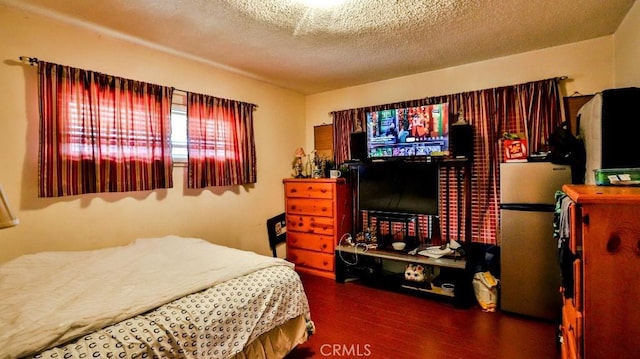 bedroom with dark wood-style flooring and a textured ceiling