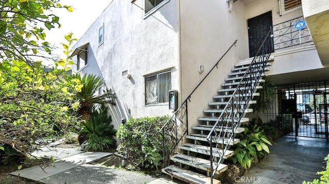 property entrance with stucco siding