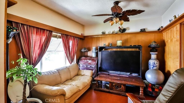 living area featuring a ceiling fan and wood finished floors