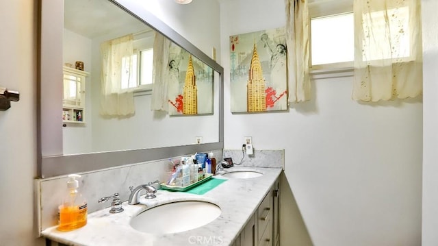 full bath with double vanity and a sink