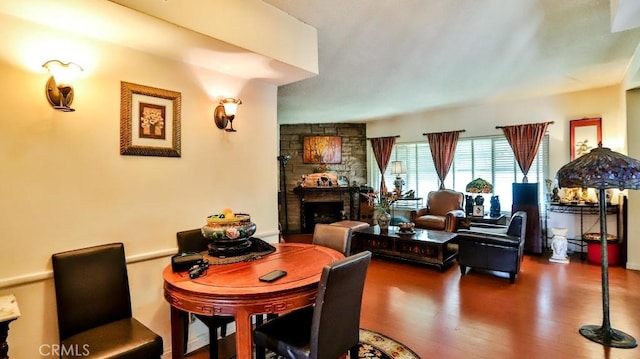 dining area with a fireplace and wood finished floors