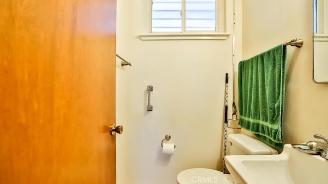 bathroom featuring toilet and a sink