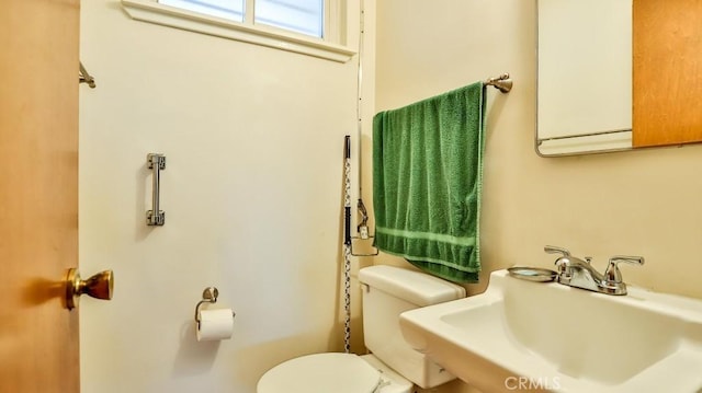 half bath featuring a sink and toilet