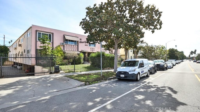 view of road with curbs, sidewalks, and street lights