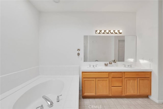 bathroom with tiled bath and vanity