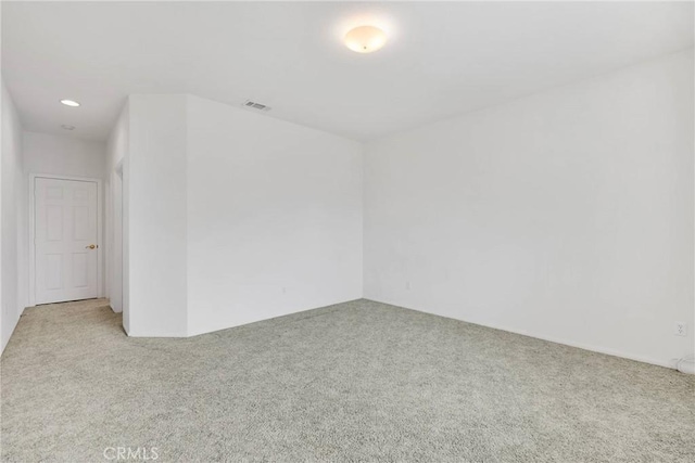 unfurnished room with light colored carpet