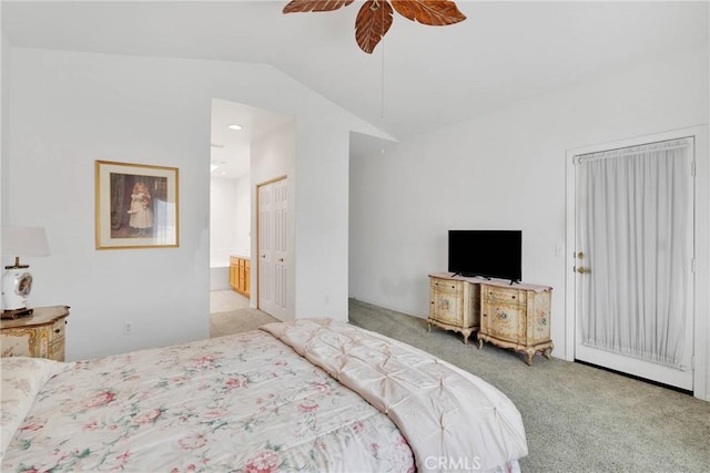 carpeted bedroom featuring lofted ceiling, ensuite bathroom, and ceiling fan