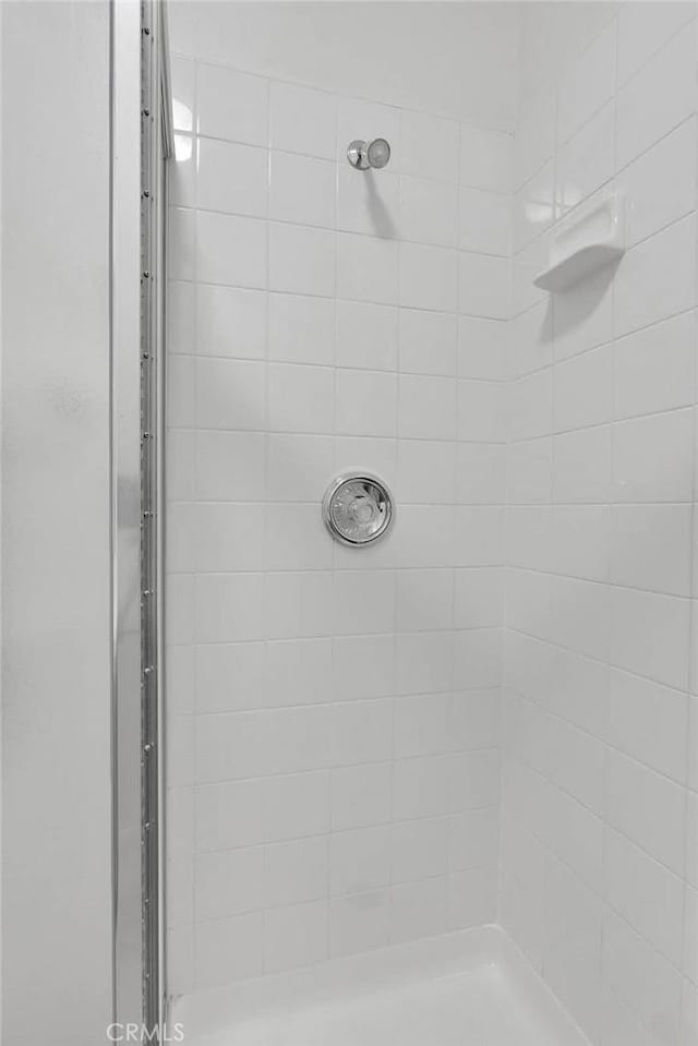 bathroom with a tile shower