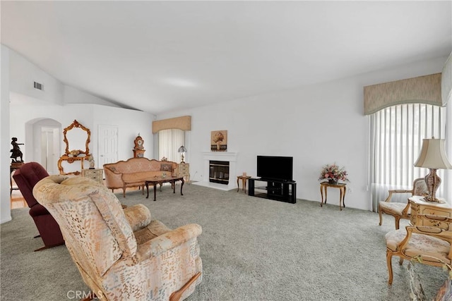 living room with light carpet and vaulted ceiling