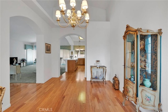 dining space featuring light wood-type flooring and a notable chandelier