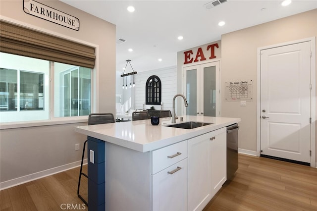 27717 Knoll View Pl, Valencia, CA 91381 - kitchen with a sink, light countertops, baseboards, white cabinetry, and dark wood-type flooring