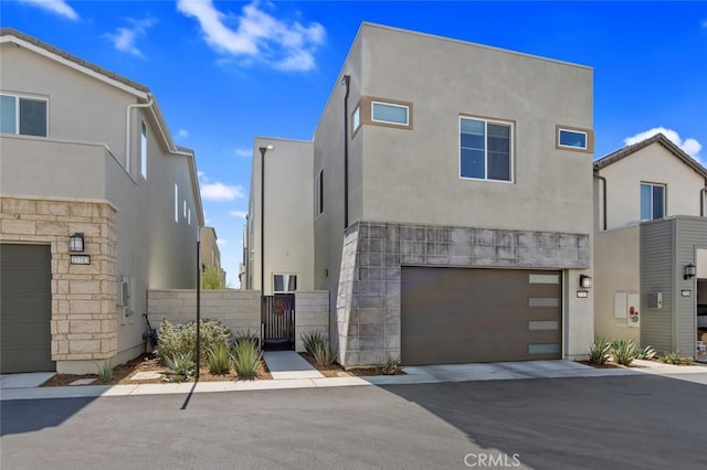 27717 Knoll View Pl, Valencia, CA 91381 - contemporary home featuring an attached garage, stucco siding, and stone siding