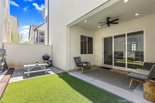 27717 Knoll View Pl, Valencia, CA 91381 - back of property featuring a ceiling fan, a lawn, a patio area, fence, and stucco siding