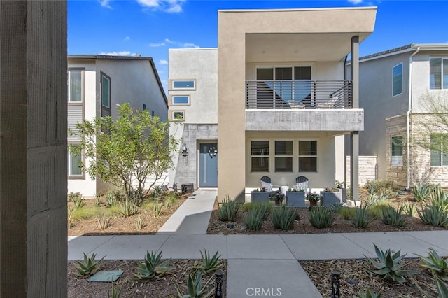 27717 Knoll View Pl, Valencia, CA 91381 - modern home with covered porch, a balcony, and stucco siding