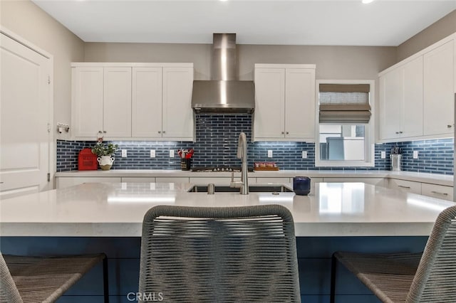 27717 Knoll View Pl, Valencia, CA 91381 - kitchen with a kitchen breakfast bar, backsplash, wall chimney exhaust hood, and white cabinets