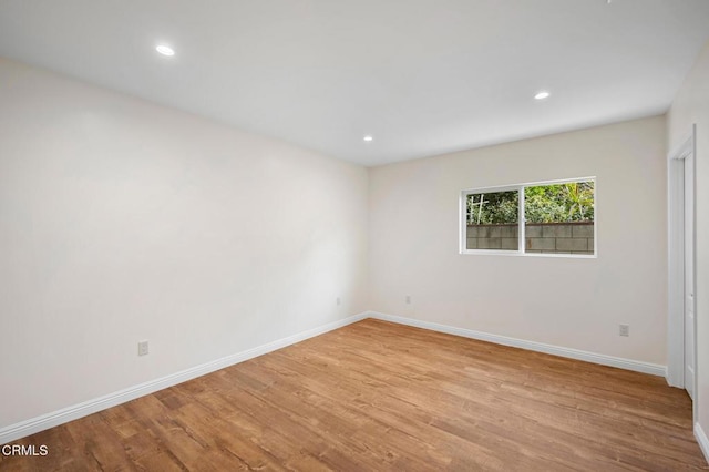 empty room with light hardwood / wood-style flooring