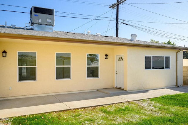 exterior space with cooling unit and a patio area