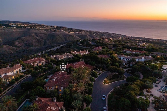 aerial view at dusk with a water view