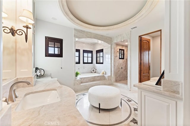 bathroom featuring vanity, visible vents, a bath, a tray ceiling, and walk in shower