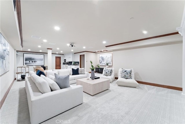 living room with ornamental molding, recessed lighting, light carpet, and baseboards