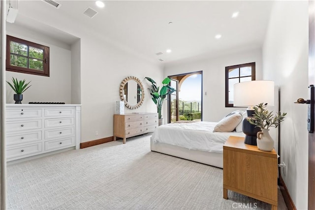 bedroom with access to outside, multiple windows, visible vents, and light colored carpet