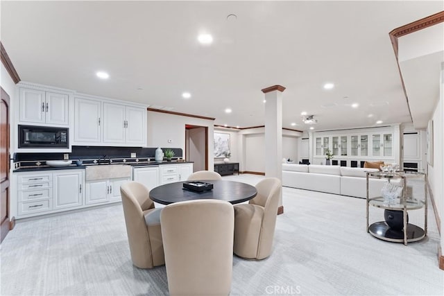 kitchen with black microwave, recessed lighting, white cabinetry, backsplash, and dark countertops