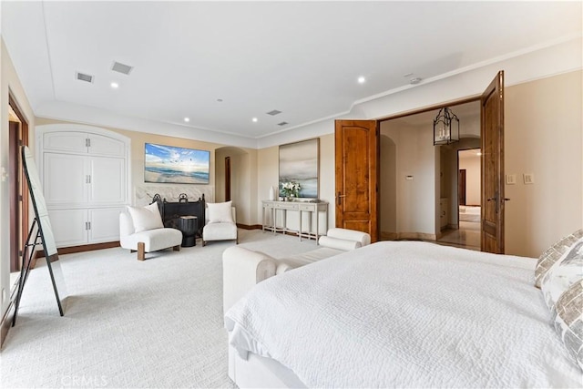 bedroom featuring light carpet, visible vents, arched walkways, and recessed lighting