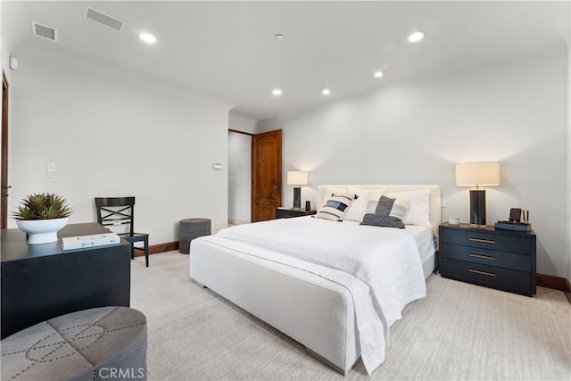 bedroom with recessed lighting, visible vents, baseboards, and light colored carpet